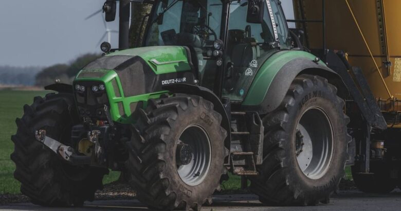Green tractor with large tires parked outdoors