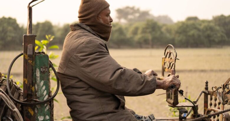 Man driving a tractor in a field